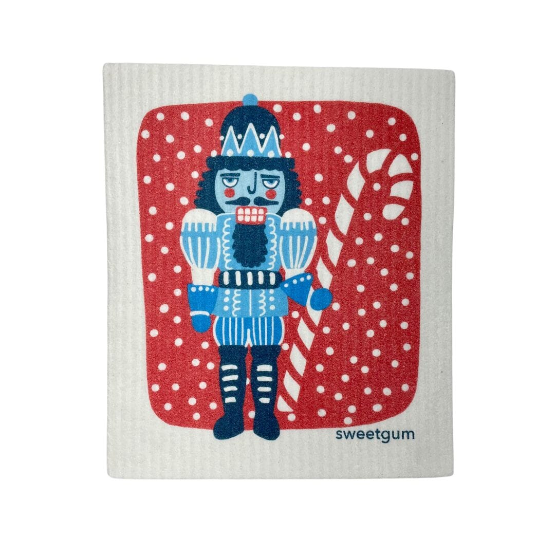 Blue Nutcracker Swedish Dishcloth | Red background with snow